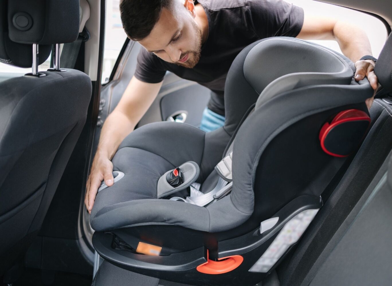 Man installing a car seat