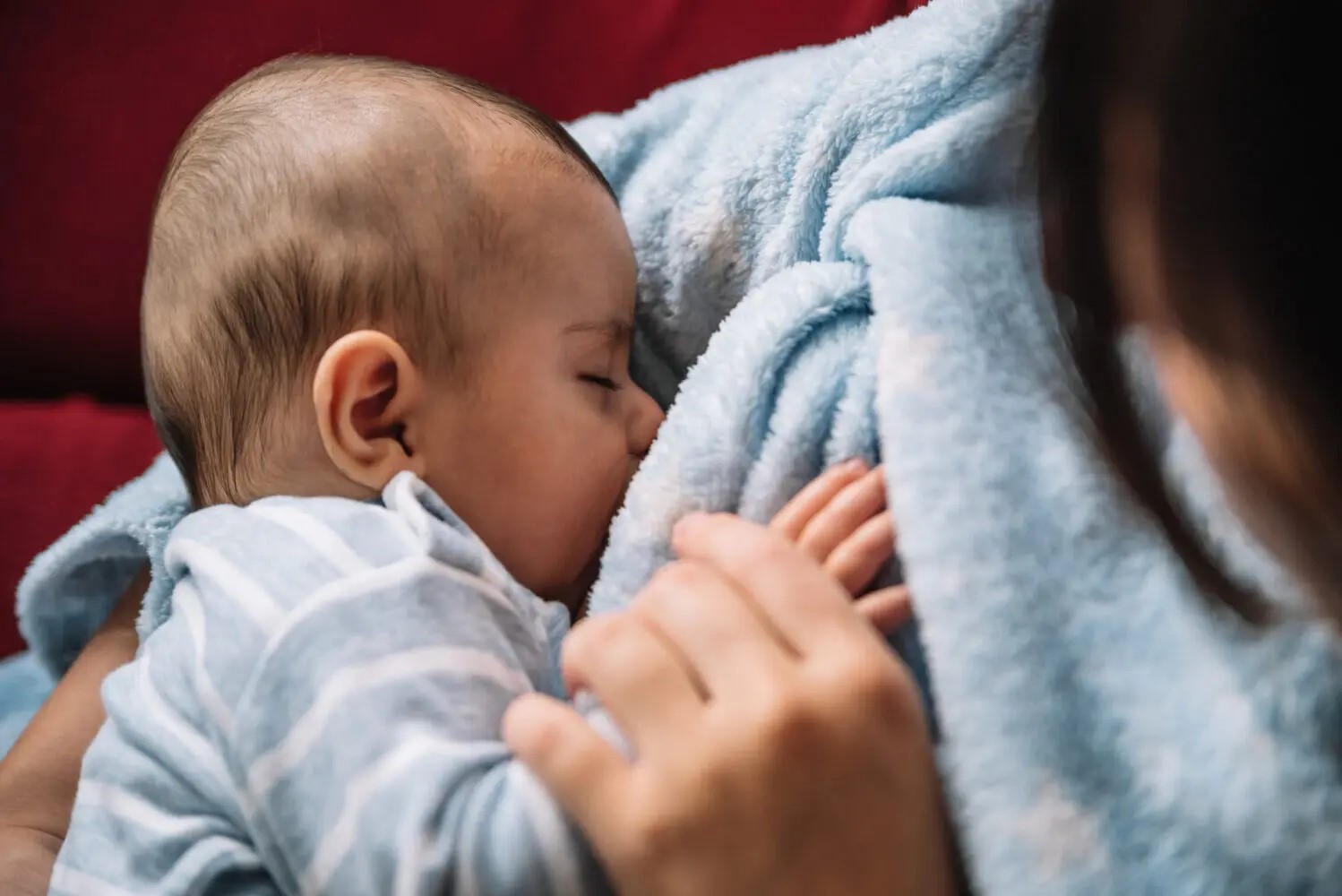 A woman breastfeeds a baby