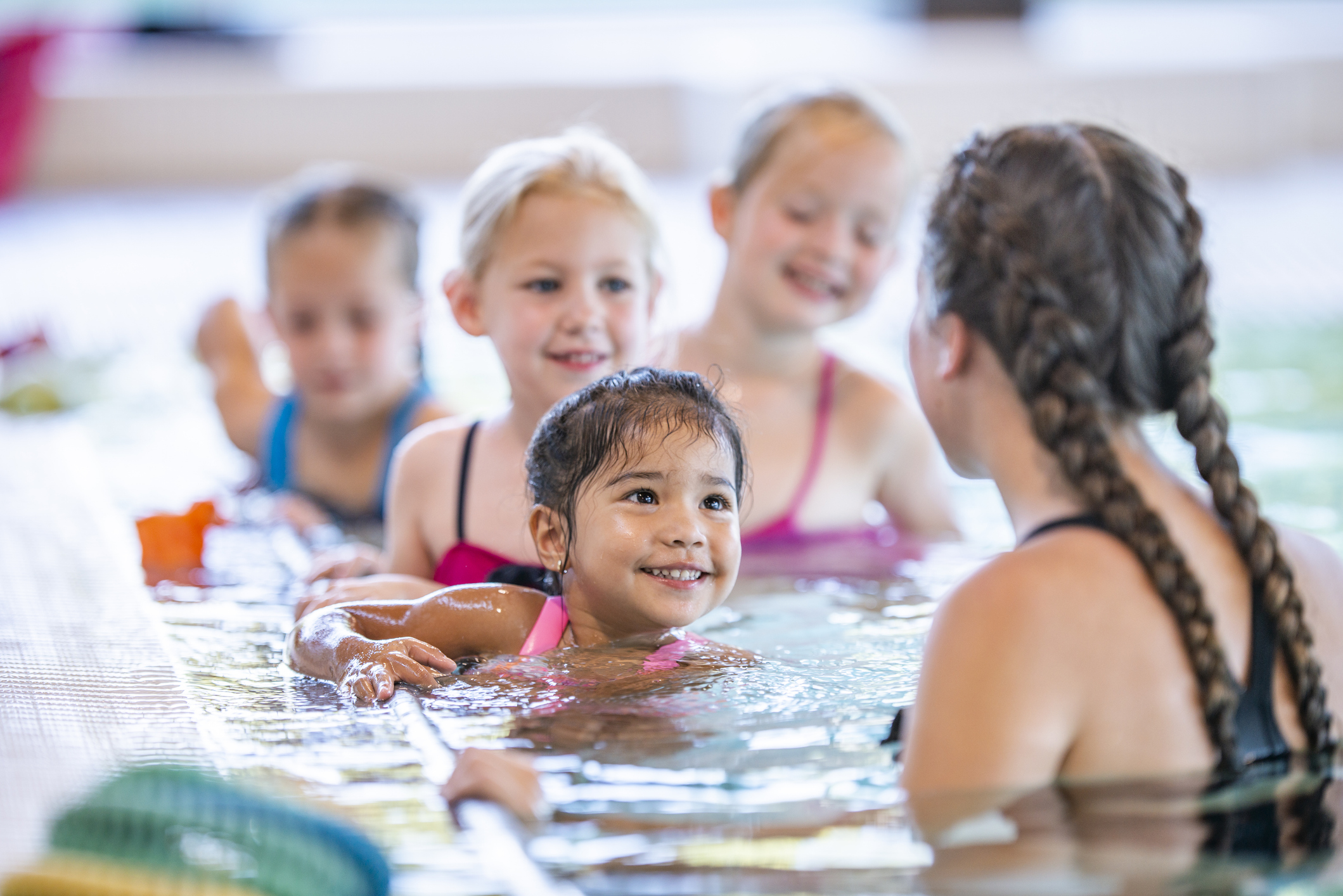 School kids are taking a swimming class
