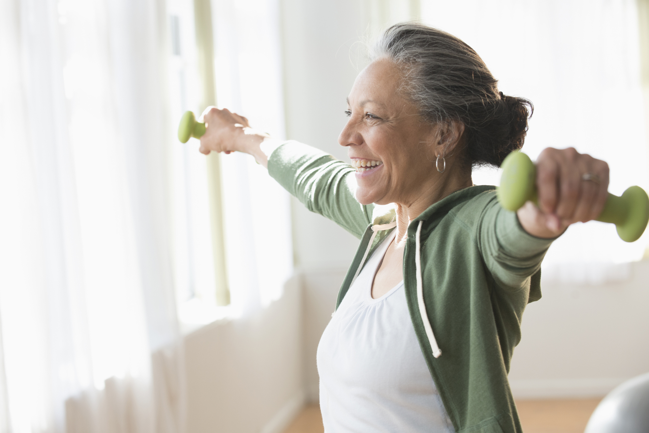 Older adult using hand weights